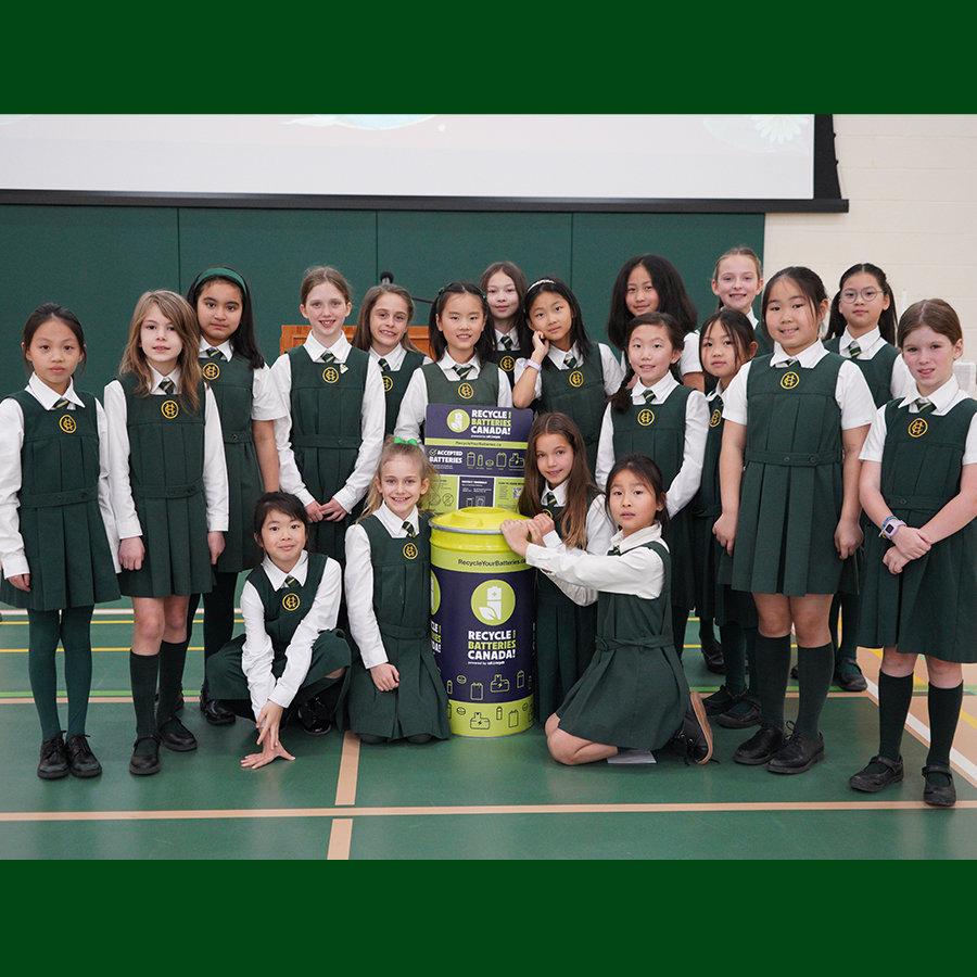 Grade 4 students with a Battery Recycling Bin at JS Earth Day Prayers.